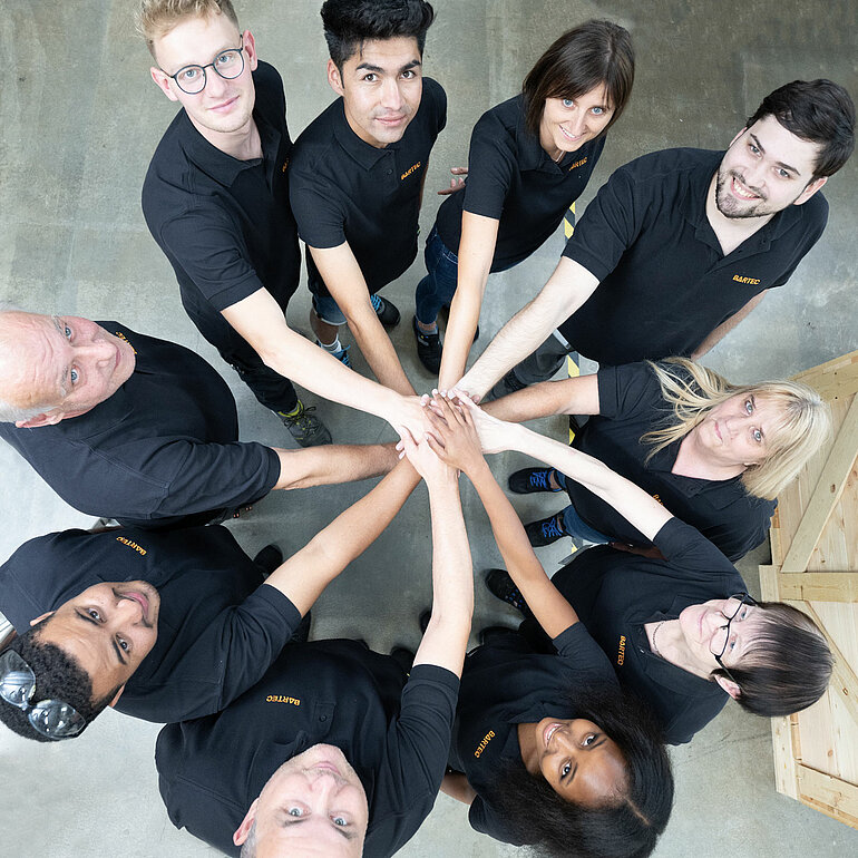 BARTEC employees standing in circle and looking up