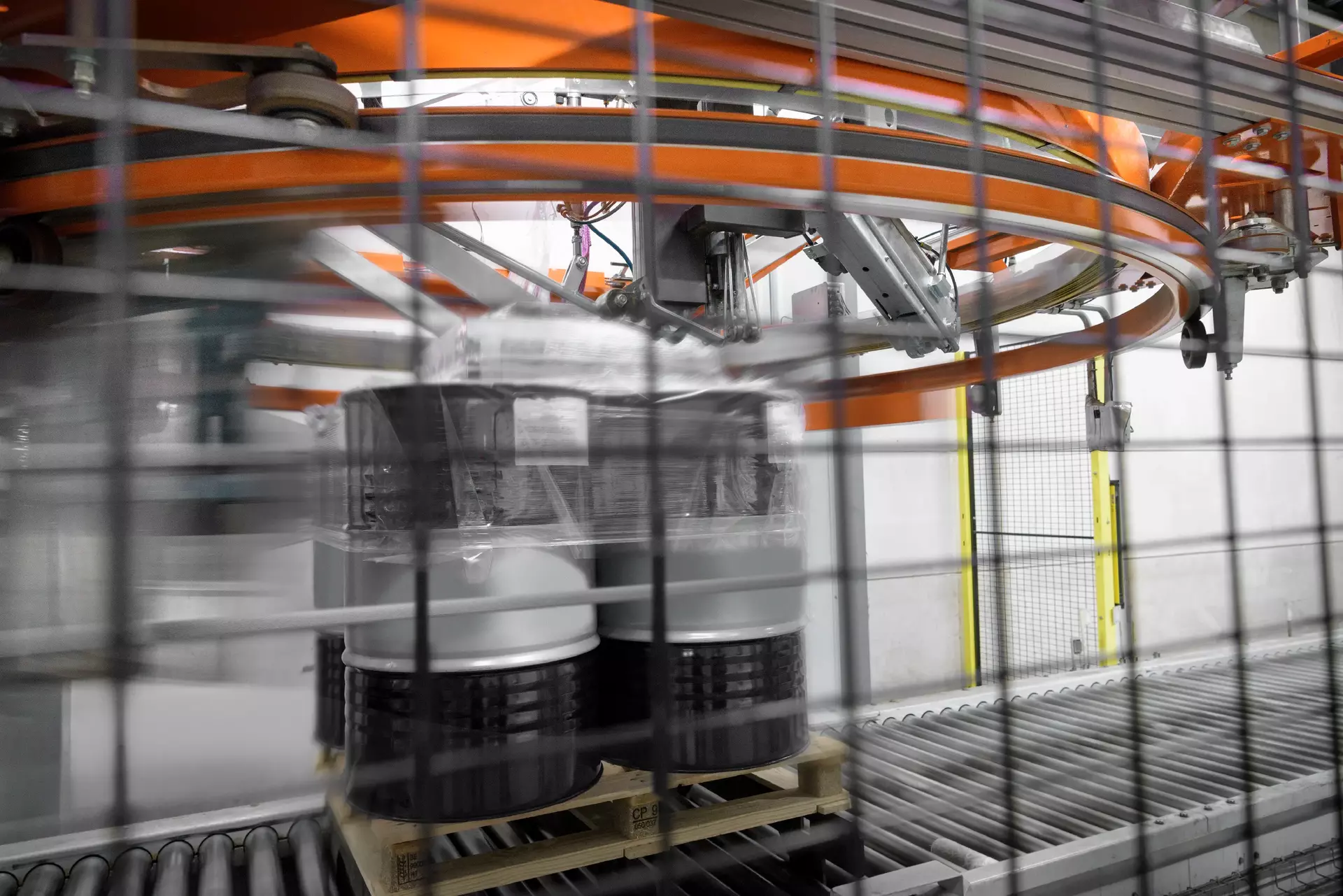 Barrels of oil being wrapped in plastic in oil blending factory