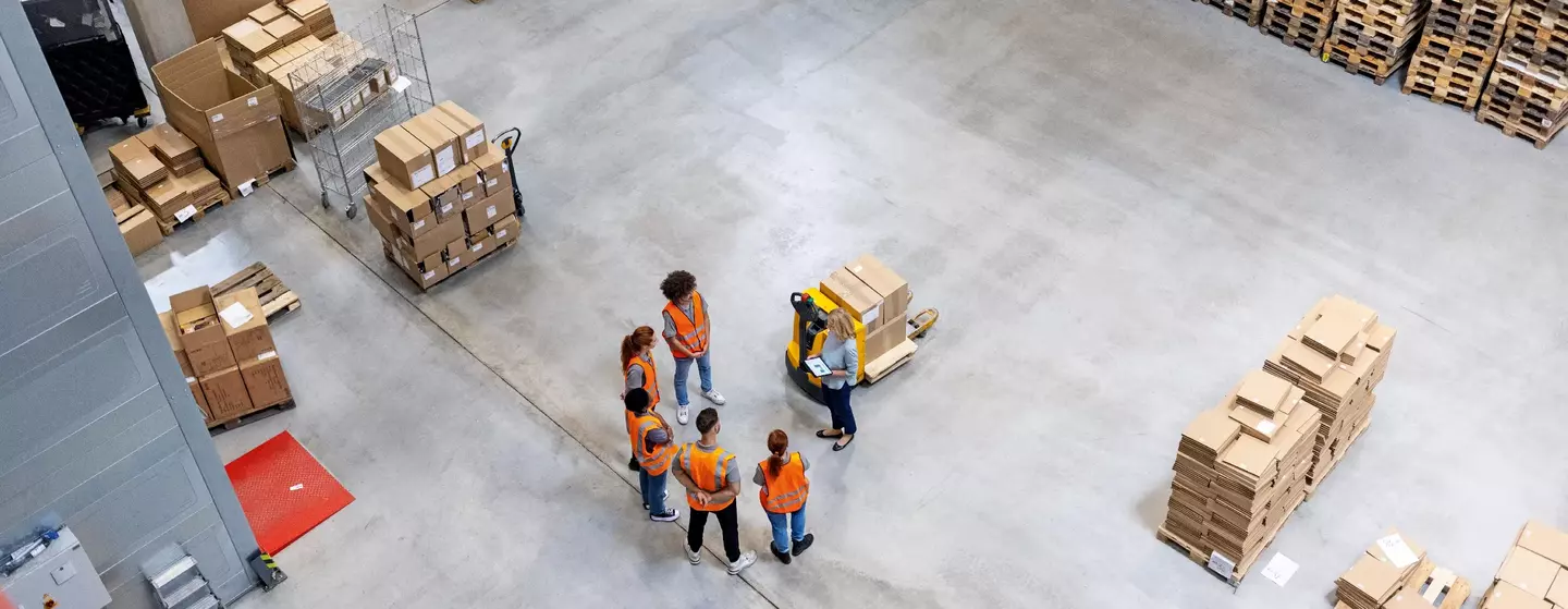 High angle view of warehouse dispatch team meeting