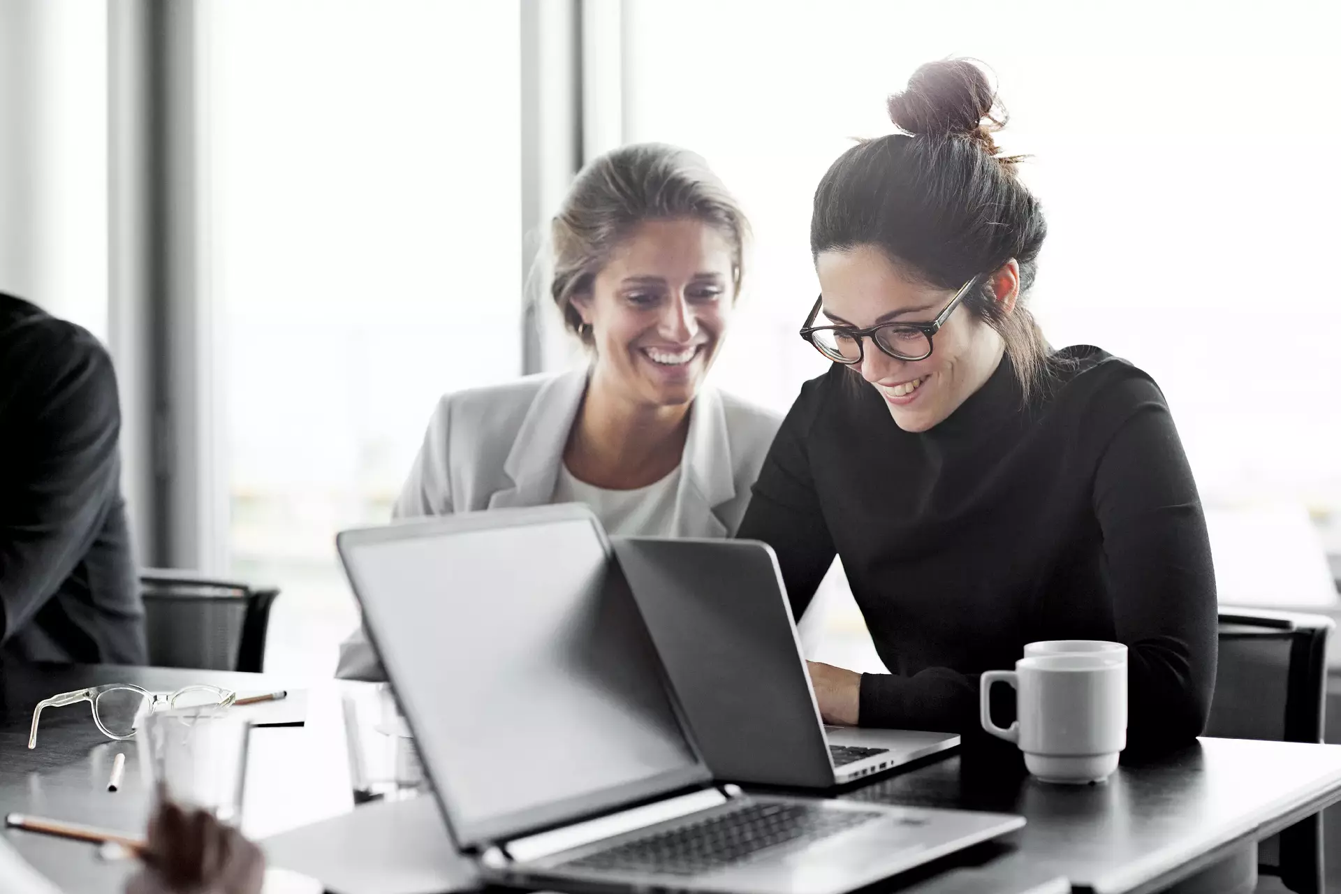 Co workers having meeting with laptop in conference room