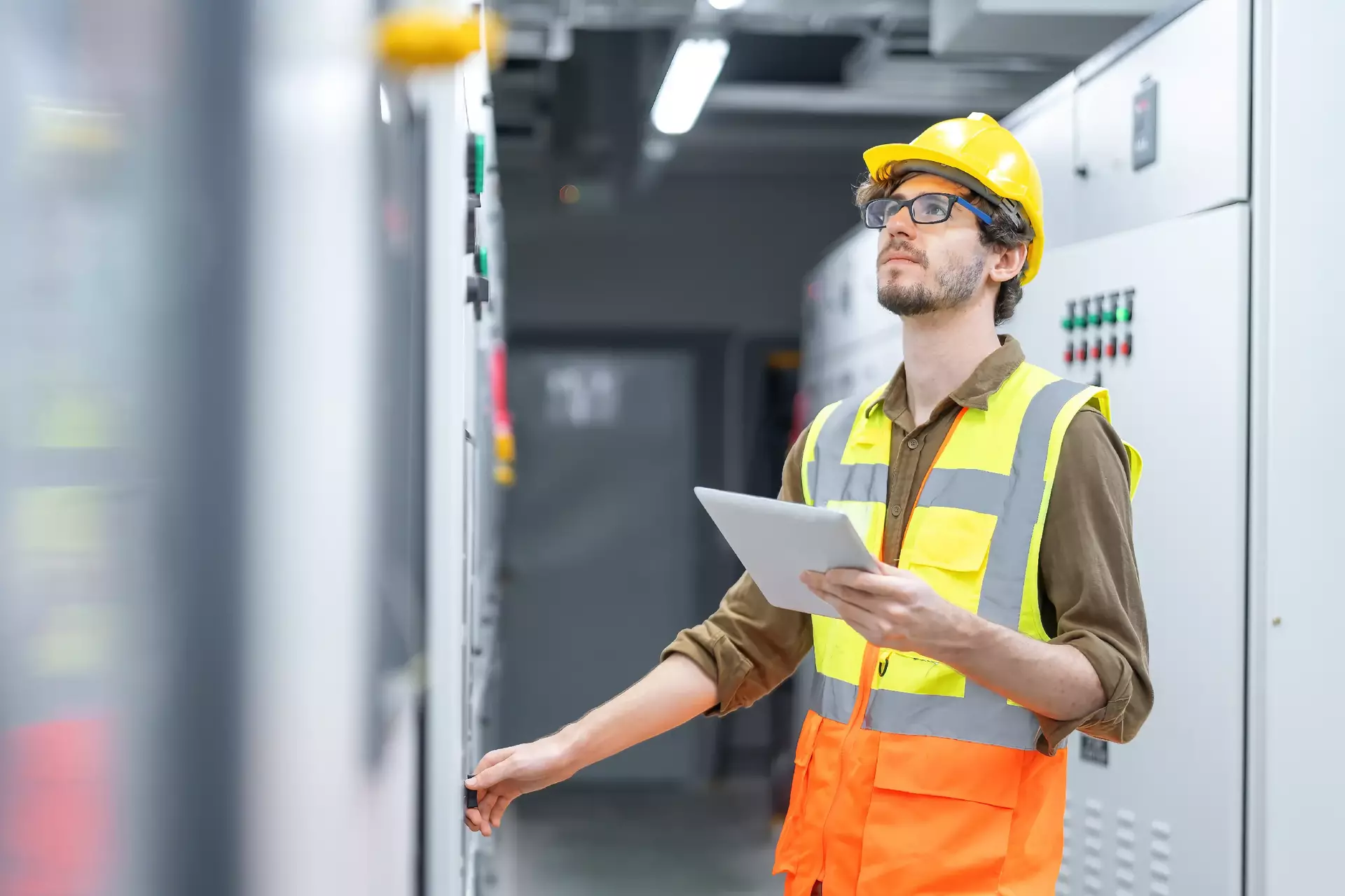 Engineer working and check status switchgear electrical energy distribution at substation room