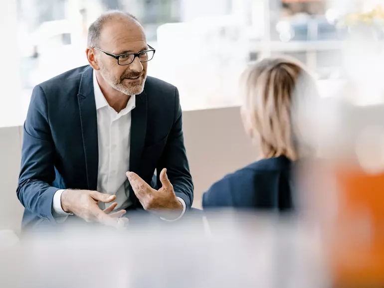 Businessman and woman having a meeting discussing work