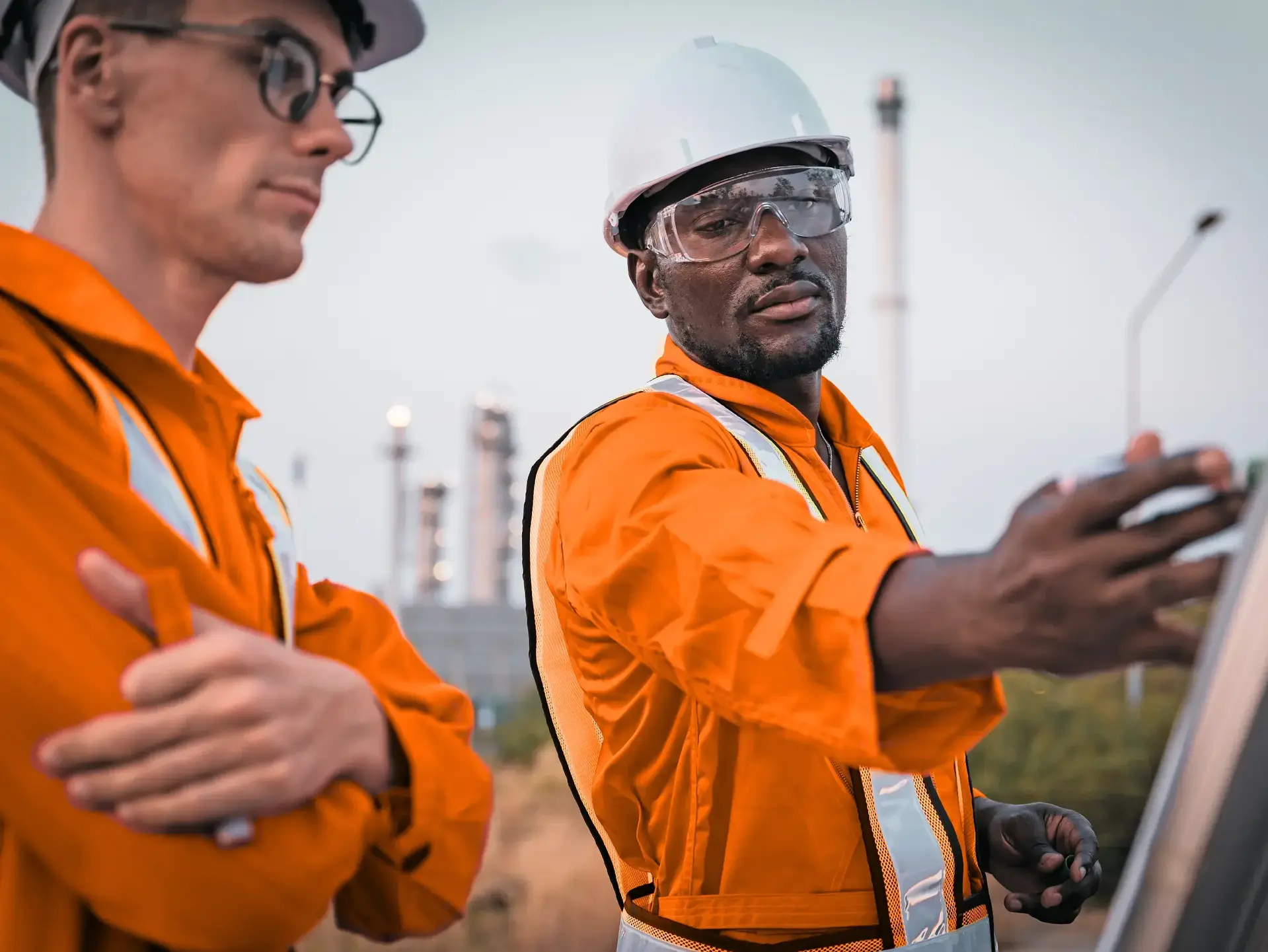 Construction engineer in front of oil refinery plant