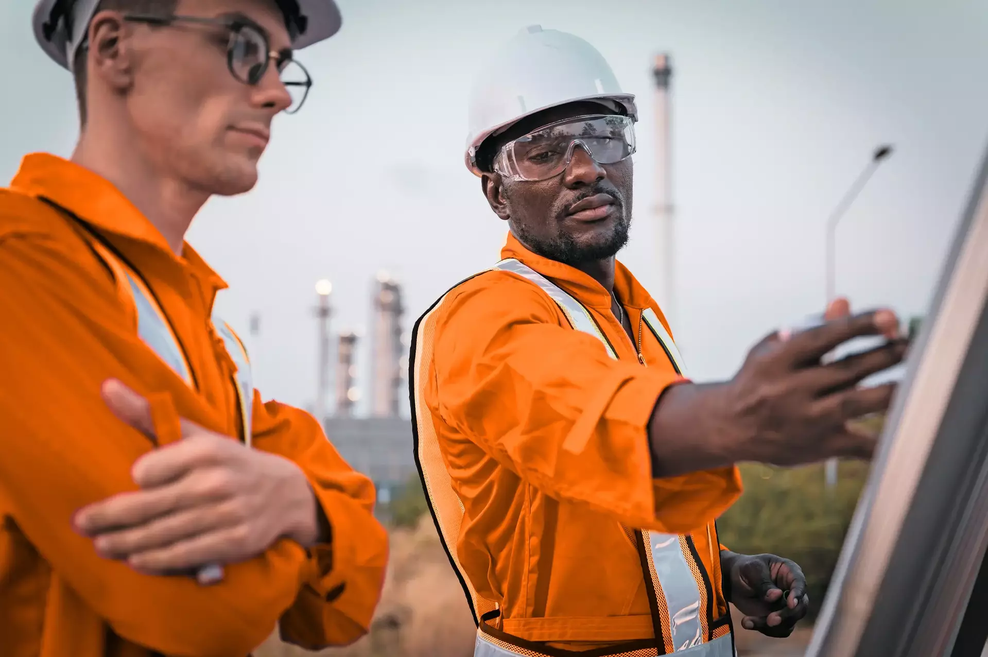 Construction engineer in front of oil refinery plant