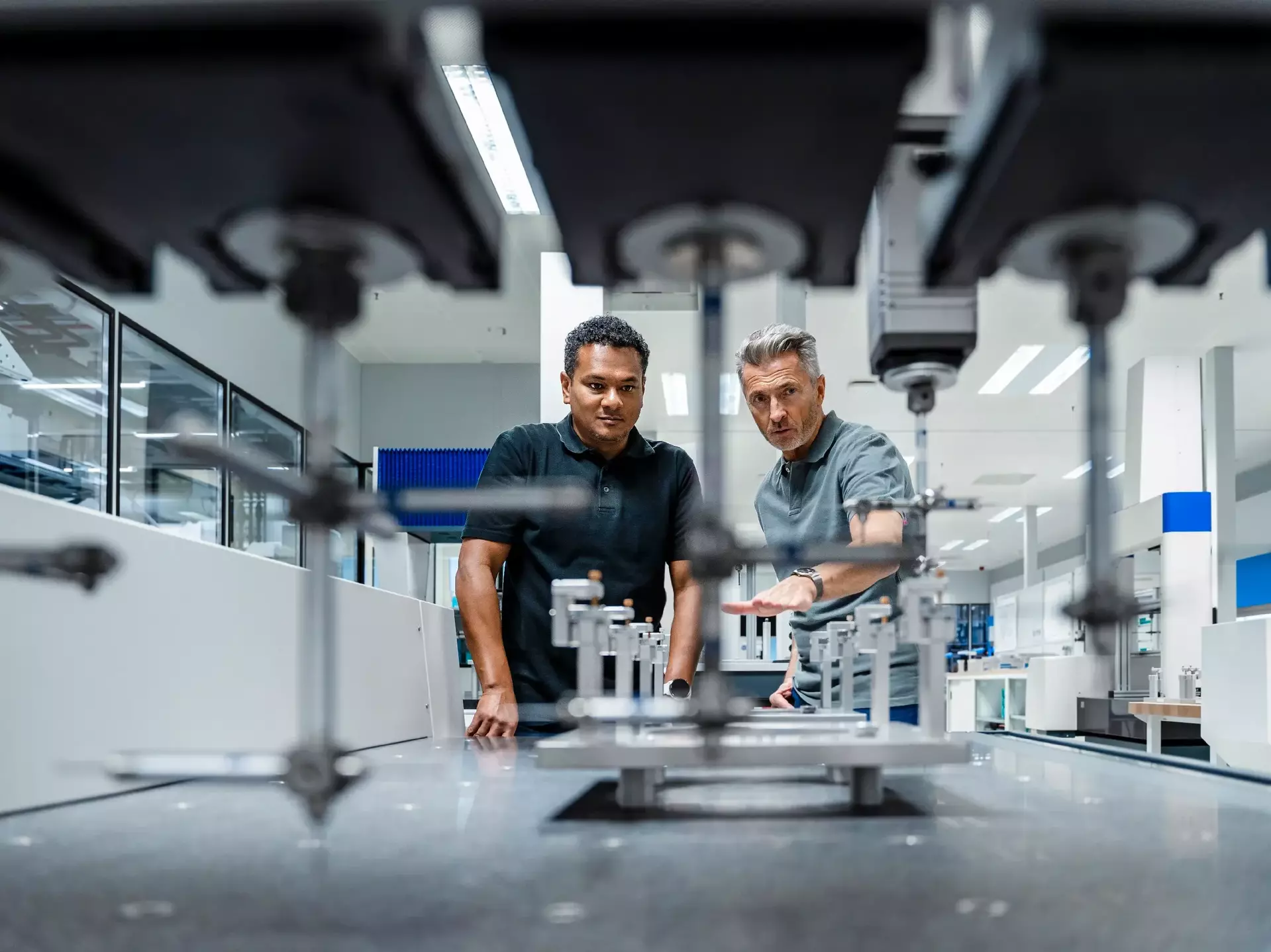 Engineers discussing over machinery at factory