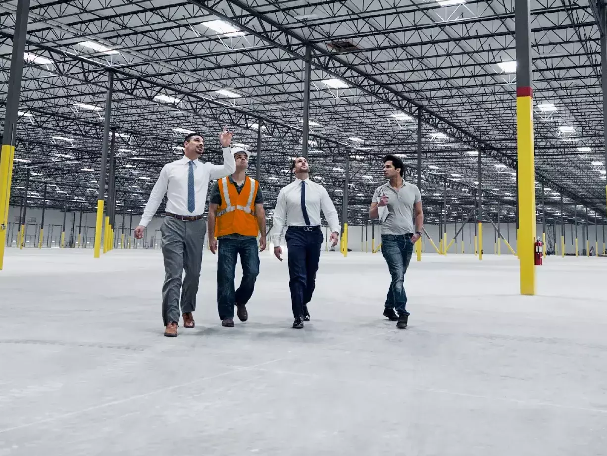 Businessmen walking and talking in empty warehouse