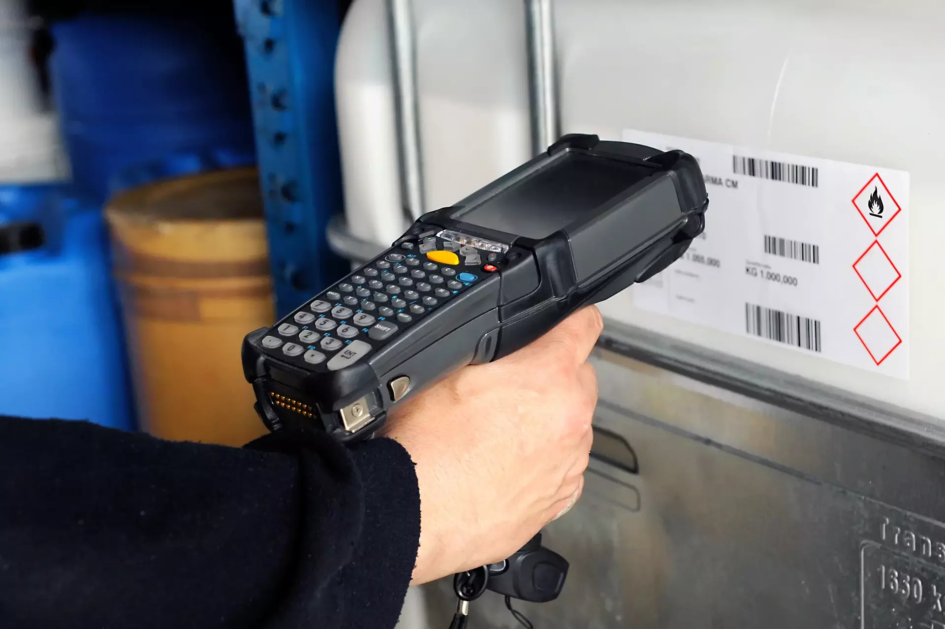 Human hand holding barcode scanner for scanning codes