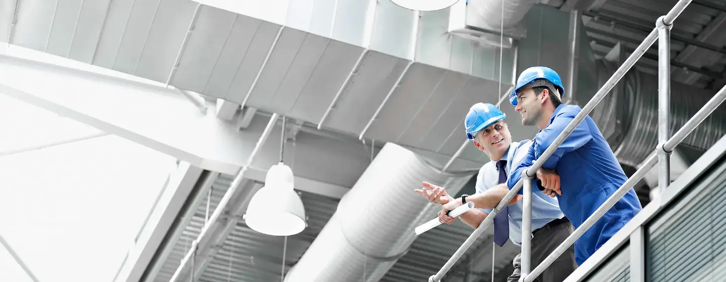 Businessmen in hard hats talking