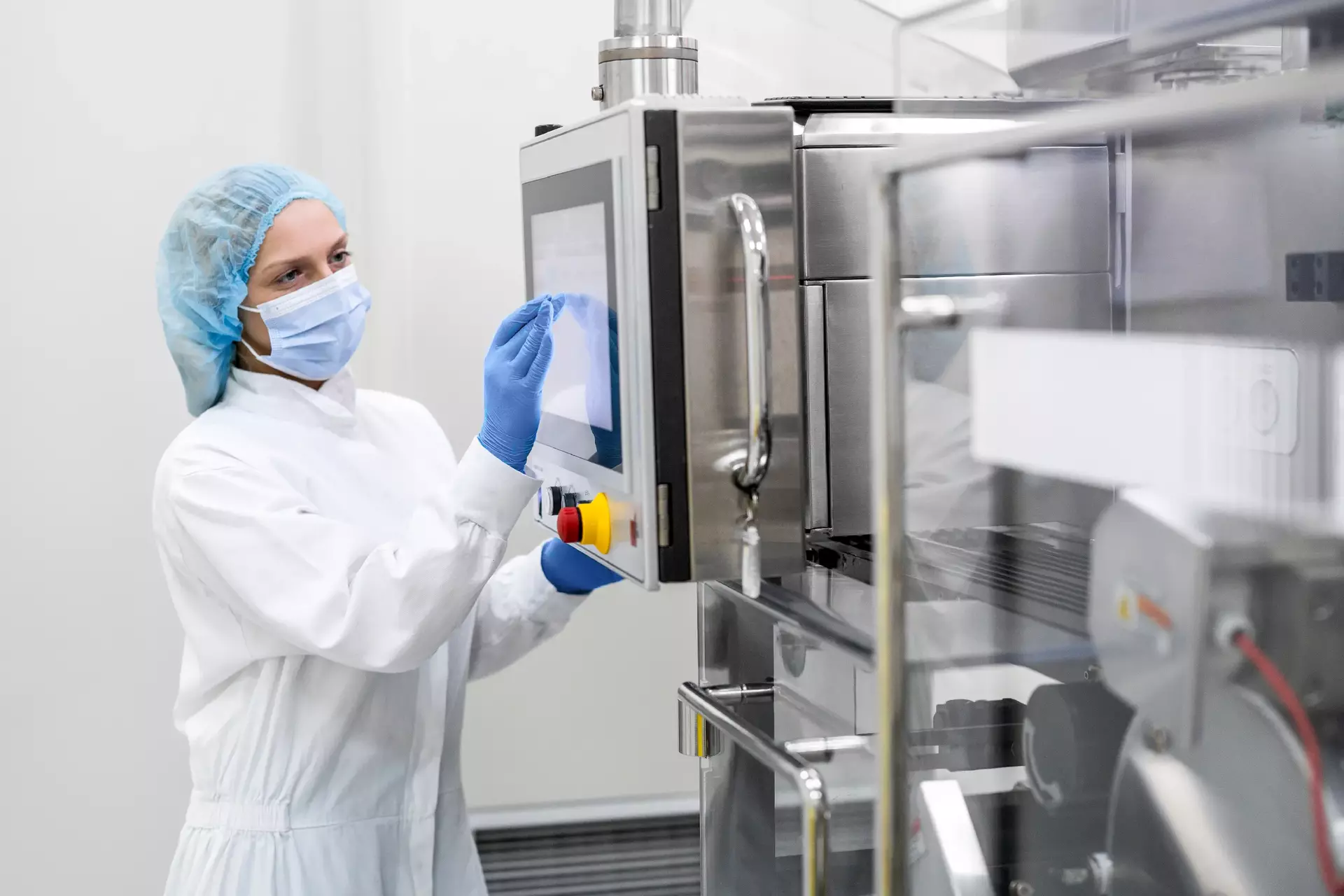Woman setting up human interface in pharmaceutical manufacturing