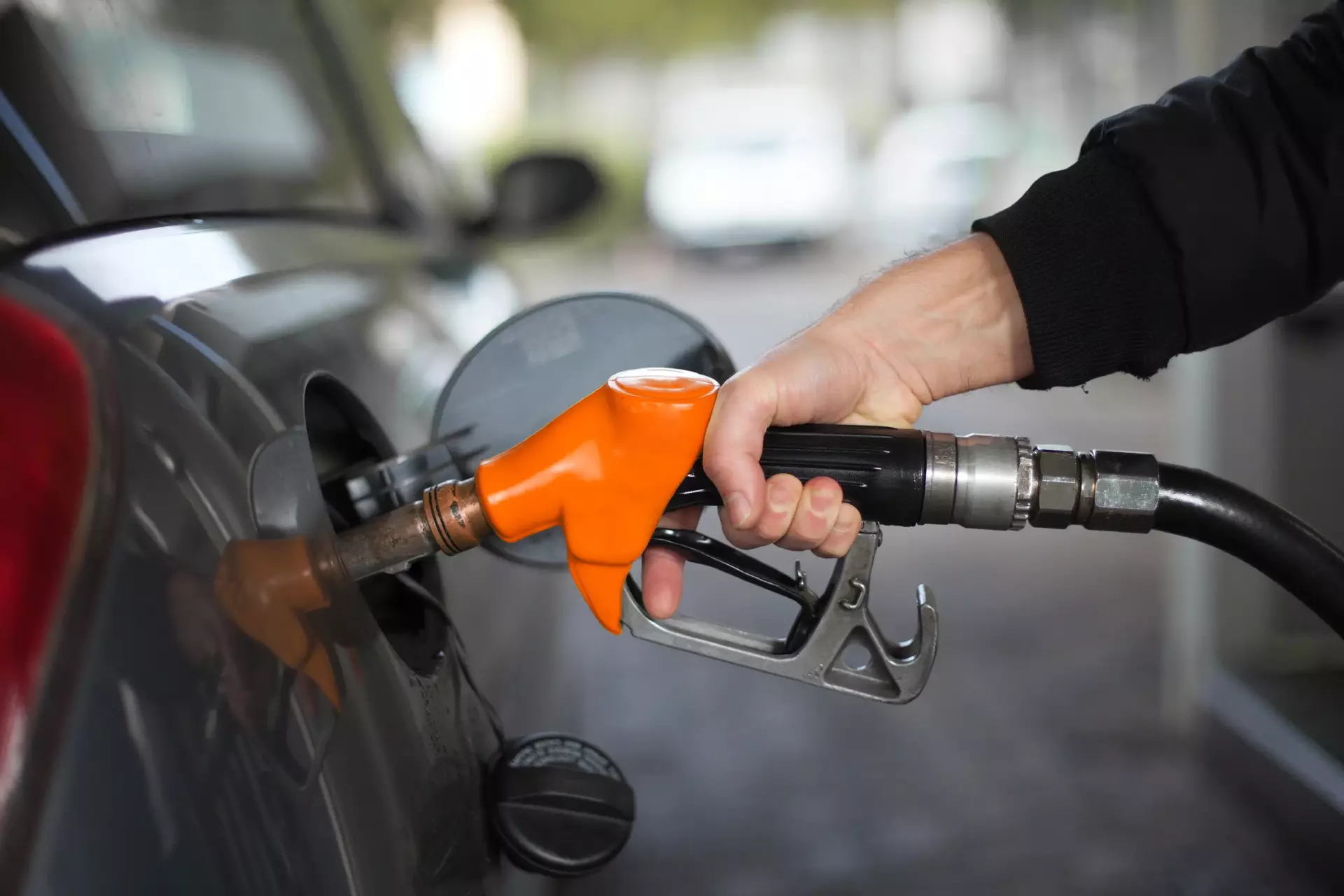 Close up of hand holding fuel nozzle