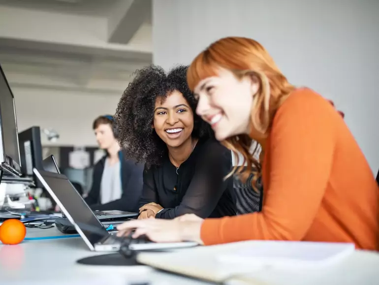 Two female colleagues in office working together