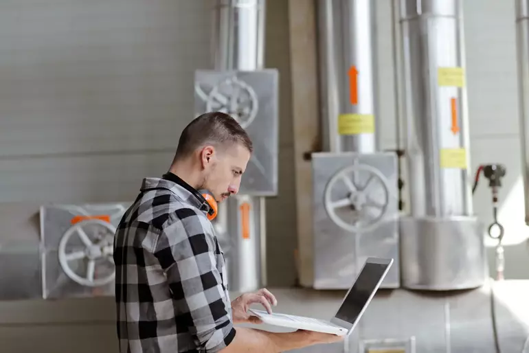 Young technician is checking his laptop